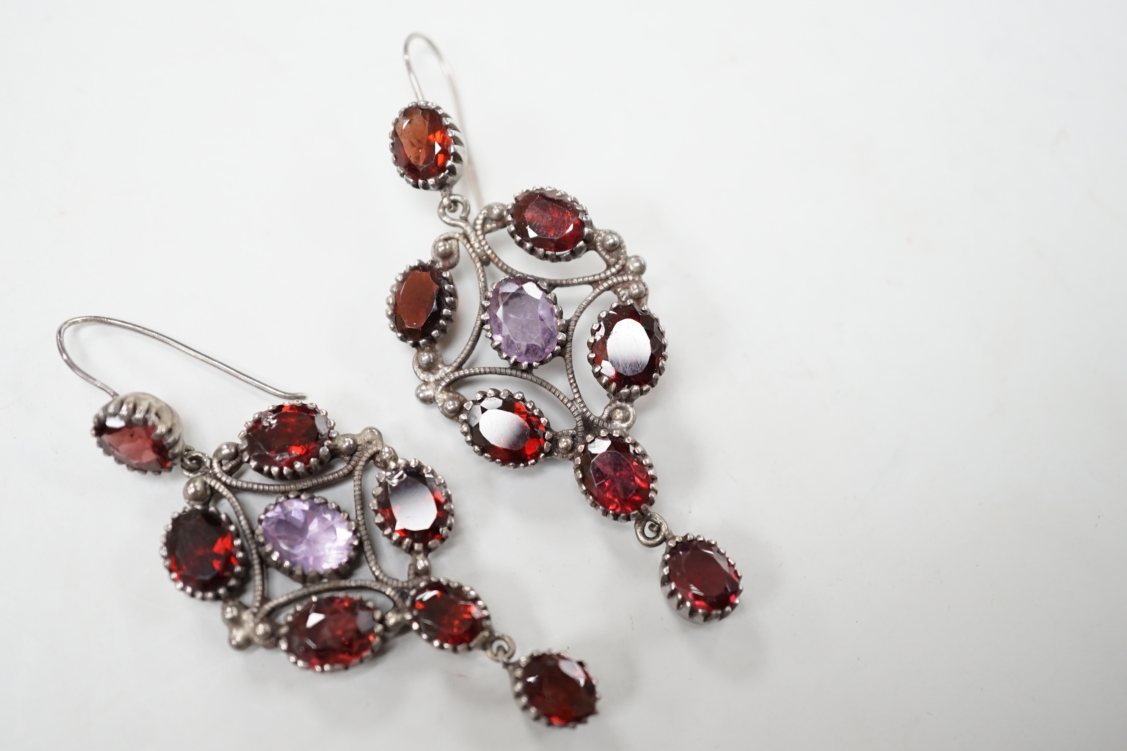 A pair of late 19th/early 20th century white metal and two colour paste cluster set drop earrings, 72mm.